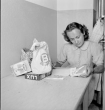 Young woman with her shopping; 1945
