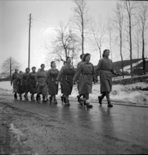 Auxiliary troops; women marching to work; 1942