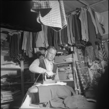 Tailor ironing Sunday suits, Oberaar power plant construction site 1951