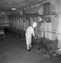 Cook, stirring, pot. large kitchen. soup kitchen. 1941