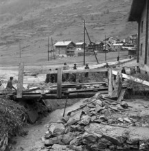 Clearance work after flood in the valais village Täsch. . 1957