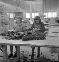 Women sorting used tyres, rubber soles. 1941