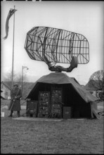Soldier with parabolic antenna of anti-aircraft defence, Emmen 1965