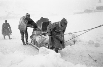 Reckingen: Military search-troupe pulling sleigh with belongings of avalanche victims. 1970