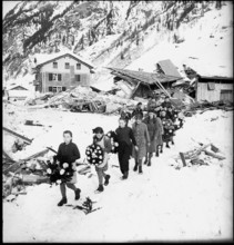 Avalanche in Vals, clearing work at half destroyd building, 1951