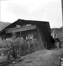 Muhen, man and boys in front of traditional thatched house, 1942