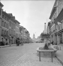 Goats walking on a street in Müstair, 1946