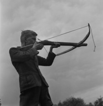 Boy shooting a crossbow, 1944