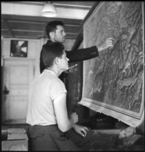 Polish internees look at a map of Switzerland; 1940