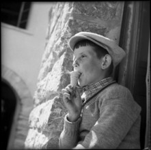 Boy eating ice cream in Chermignon, 1955