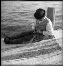 Fishermen mending nets on Lake Geneva, Ouchy 1945