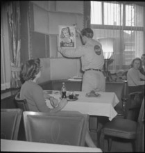 CocaCola supplier placing advertisement; 1950