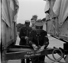 French customs officers seal Swiss trucks; 1944