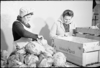 Women preparing vegetables; public kitchen; 1945.