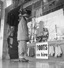Grindelwald, man looking at shop window; 1950.