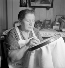Woman embroidering, 1941.