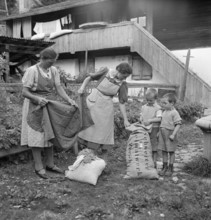 Unpacking remnants for rag rugs, 1940.