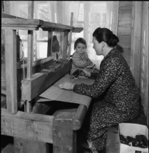 Woman with child at the loom, 1945.