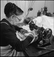 Home embroideress at work, 1942.