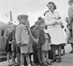 Red cross nurse with children from Domodossola; identification badge; 1944.