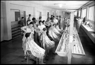 Hairdressers cutting hair of recruits 1975.