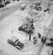 Snowfall in Lausanne: snowy street; 1952.