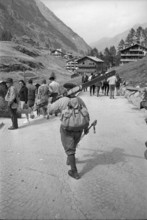 Skier carrying his skis, 1967.