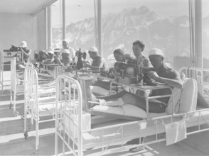 Leysin: patients in a sanatorium sawing shoes, ca. 1935.