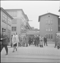Workers leaving off work; 1943.