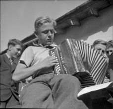 young boy playing accordion.