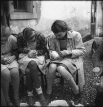 Preparations for Räbeliechtli procession, girls carving in turnips, 1945.