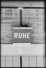 Breeding blackbird's nest on lamp with letters 'Ruhe' 1970.