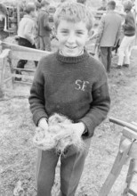 Braechete, in Zaeziwil, boy with a handful of flax, 1965.