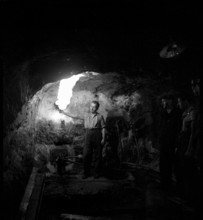 Worker in a gallery of the Bex salt mine, salt works; 1940.