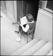 May 8th. 1945, Armistice's day: Woman reads the newspaper.