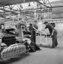 Factory workers have a break; assembly hangar; General Motors 1946.