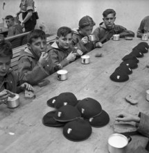 Together at the table with bread and drink.