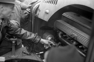 Workers learning how to use cars powered by wood gas; 1941.