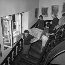 Wartegg castle; women bearing away armchair; 1962.