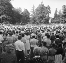 Audience listening to baptist preacher Billy Graham in Geneva, 1955.