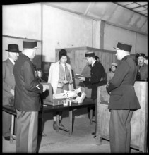 Custom officers checking woman at the customs office at Geneva-Cornavin, 1946.