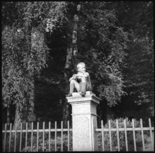 Boy sitting on a pillar, 1939.