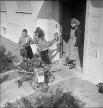 Boys collecting articles of non-ferrous metal; 1940.