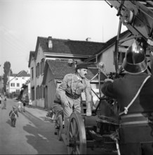 War fire brigade, positioning a ladder;  1939.