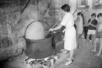 Kirschmueset in Wimmis 1970; Woman cooking.