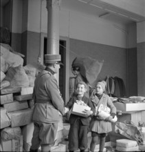 WW 2: economy of war; army officer thanking children for effot.