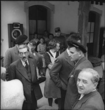 refugees; women talking with swiss journalists; 1945.