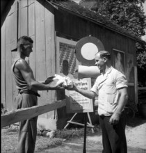 Men in front of foot-and-mouth disease warning sign, 1946.