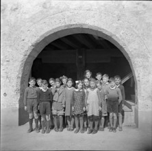 Children posing for photographer; 1941.
