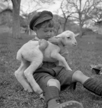 Small boy with lamb, 1944.